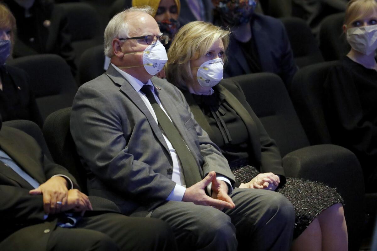 People sit with face masks on.