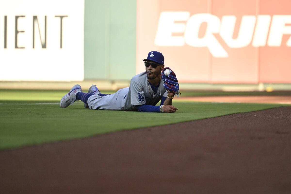 Los Angeles Dodgers right fielder Mookie Betts reacts after catching a fly ball hit.