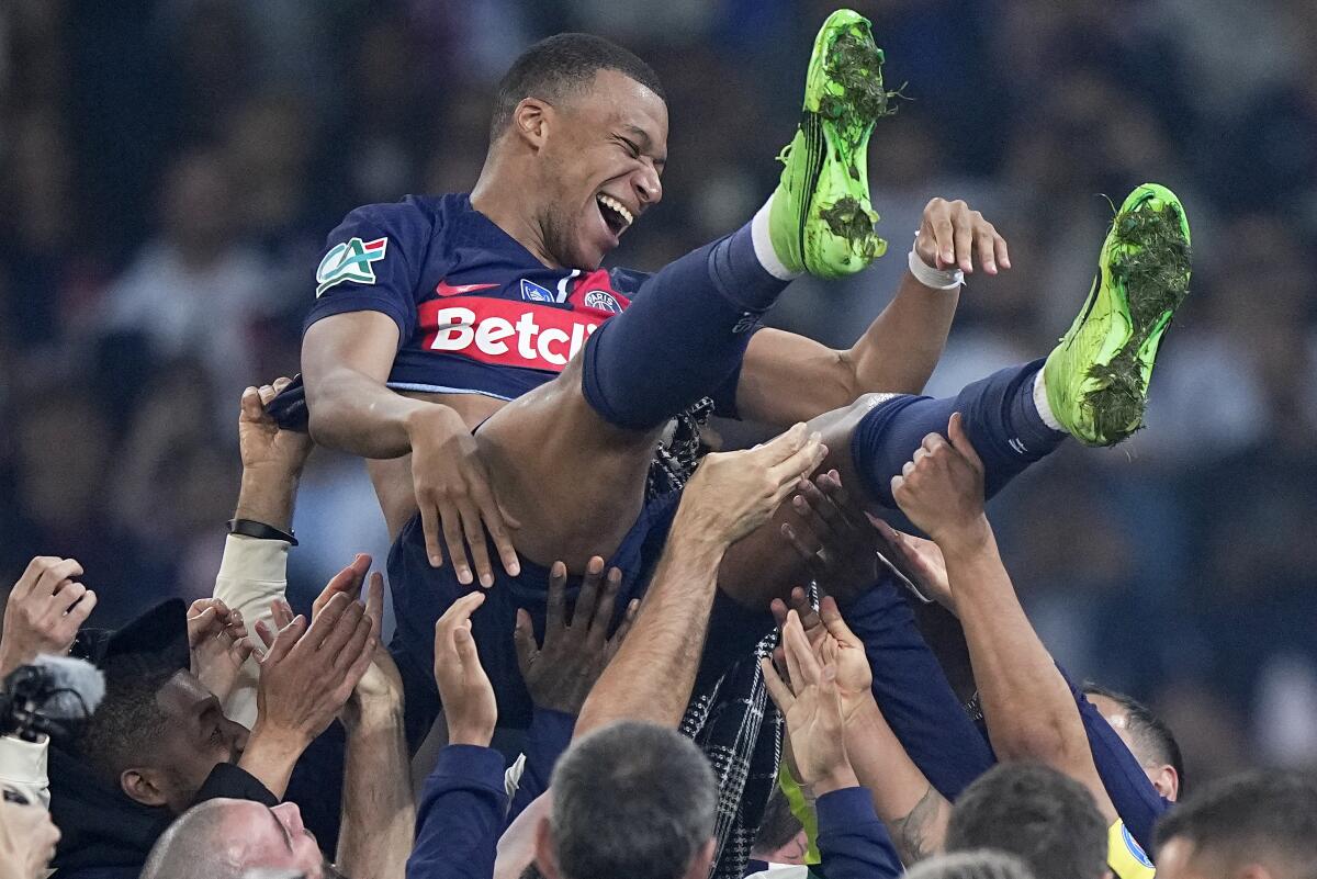 Kylian Mbappe is tossed into the air as he celebrates with teammates after the French Cup final in May.