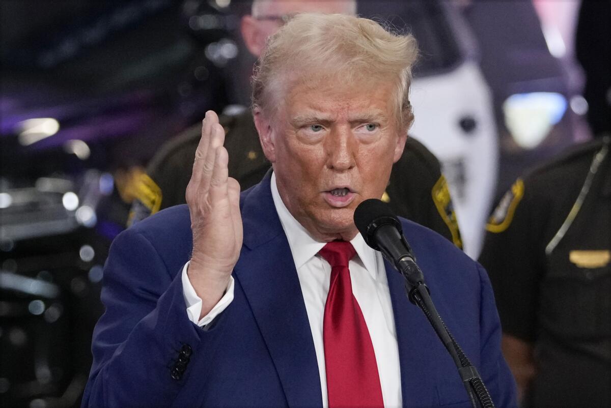 Former President Trump gestures and speaks.