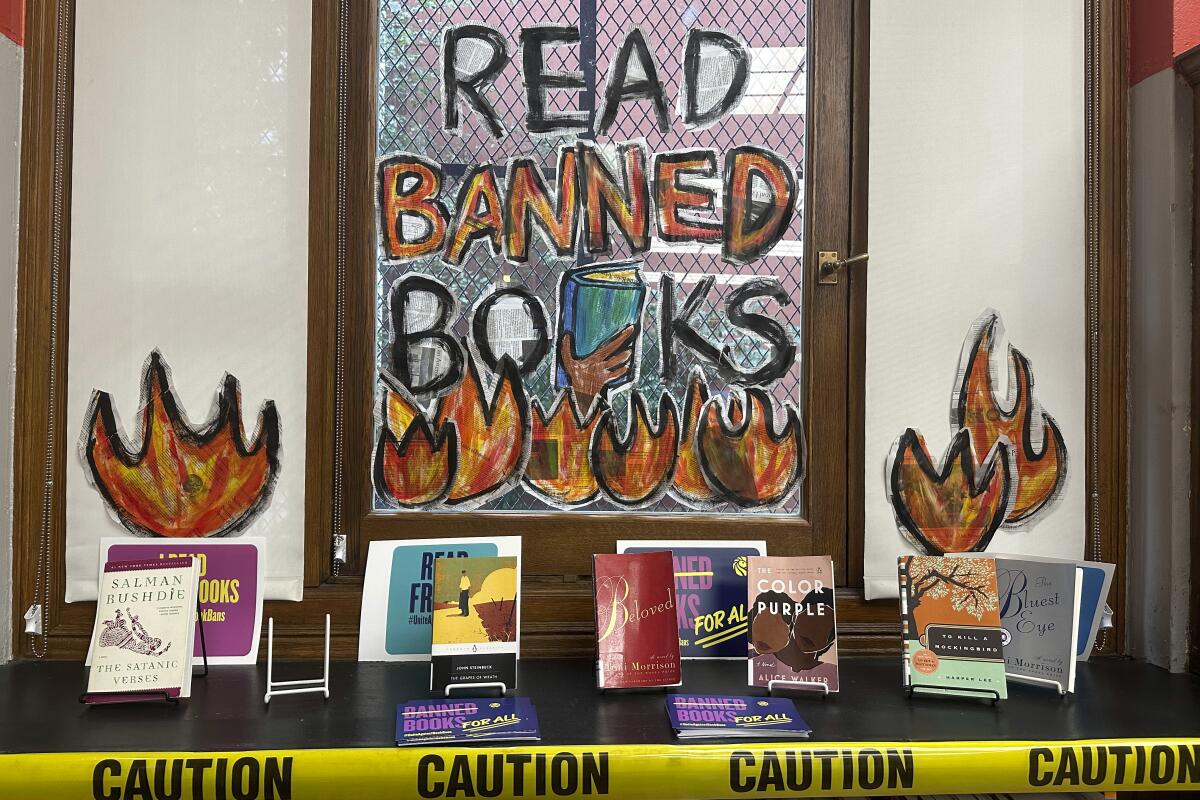 A display at a public library with a sign that says, "Read Banned Books." 