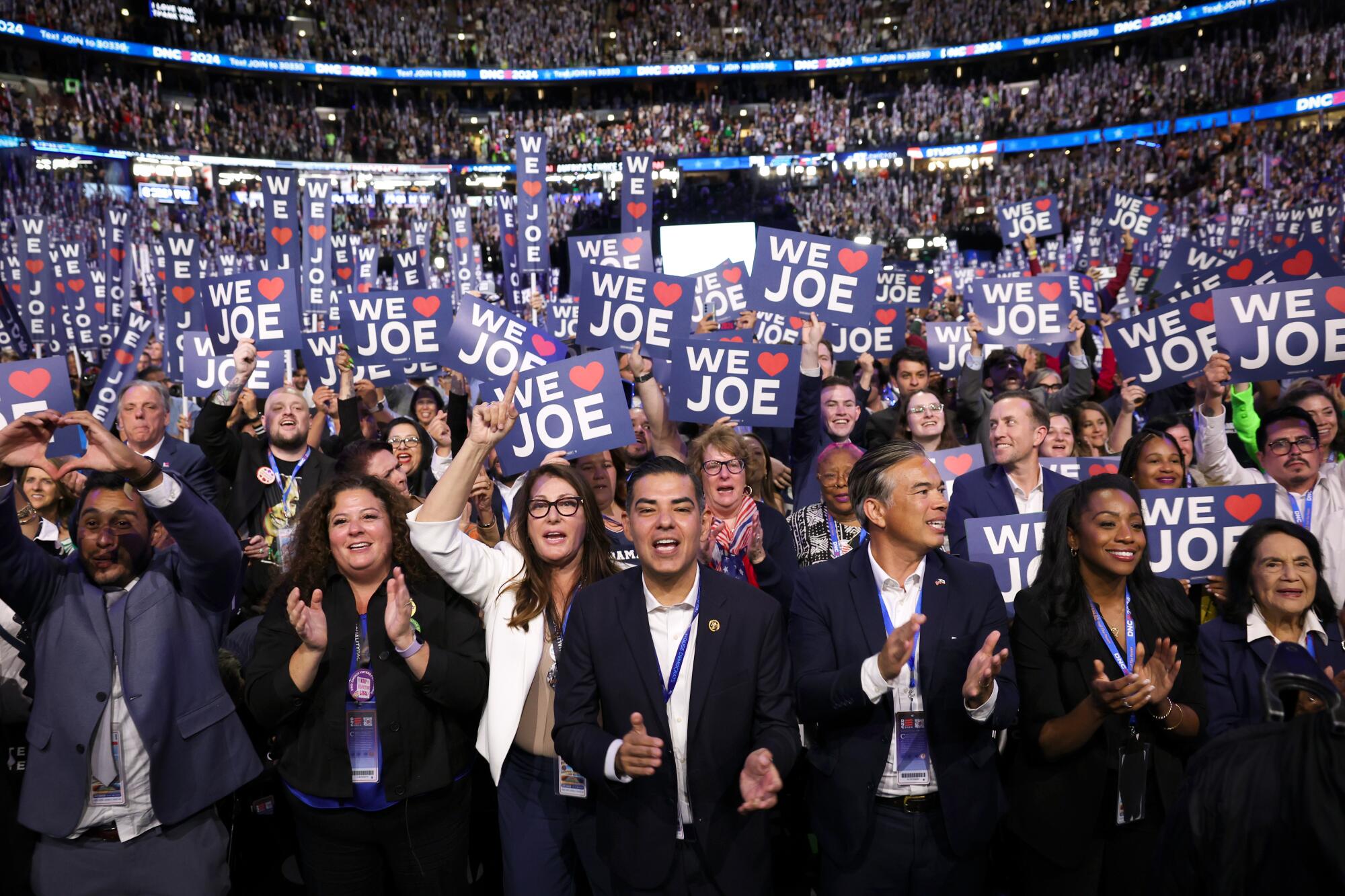  Rep. Robert Garcia, center, along with the California delegates cheer as President  Biden speaks Monday.