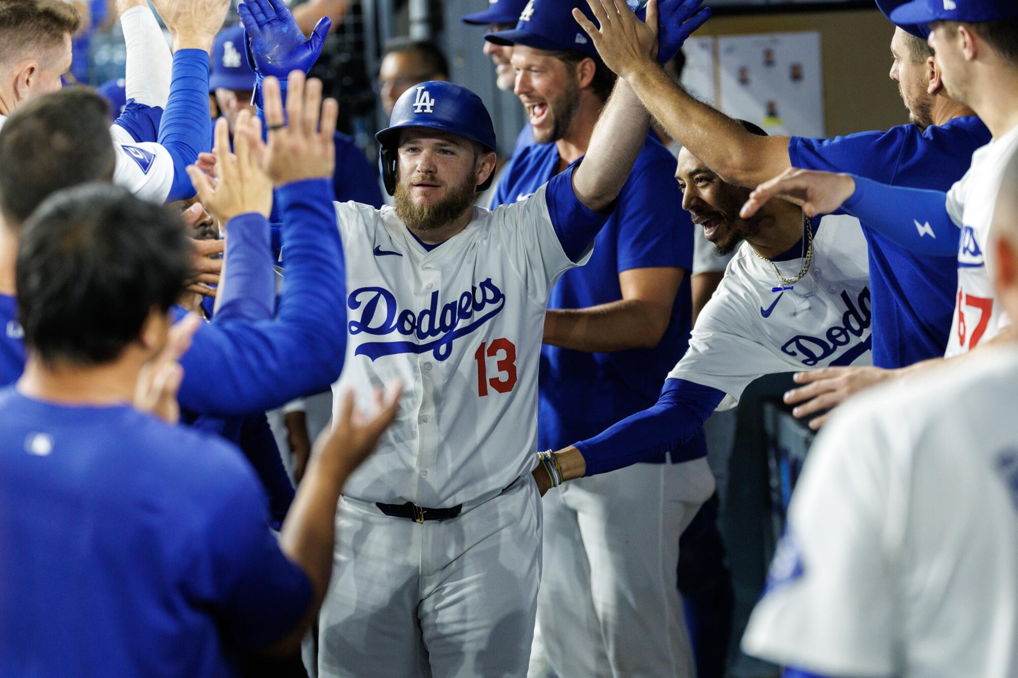 Max Muncy celebrates in the dugout after hitting a solo home run against the Mariners on Tuesday.