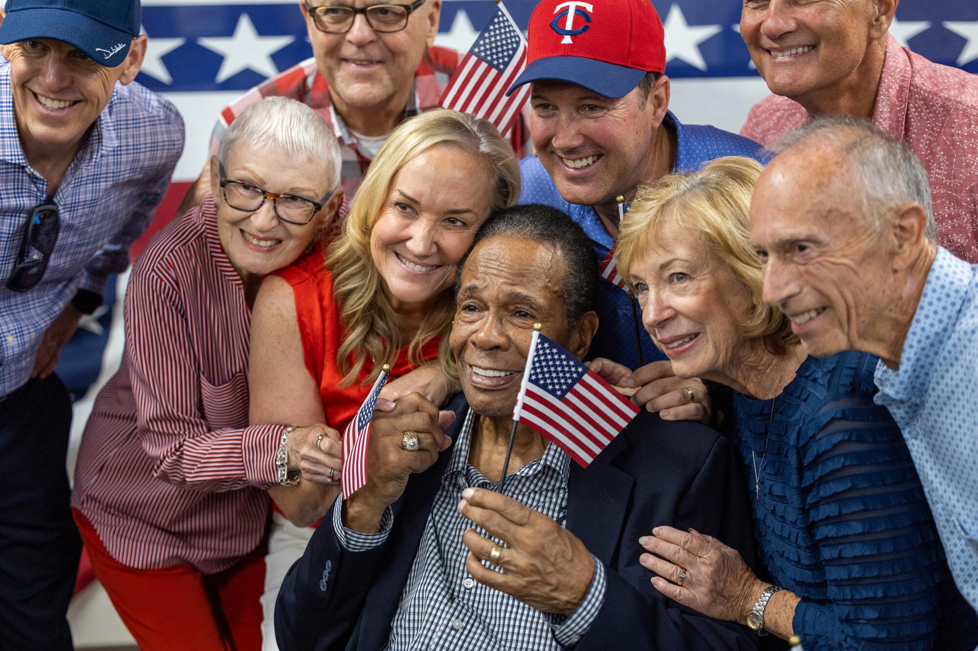 Angels legend Rod Carew, center, celebrates with family, friends and officials after becoming a U.S. citizen on Friday.