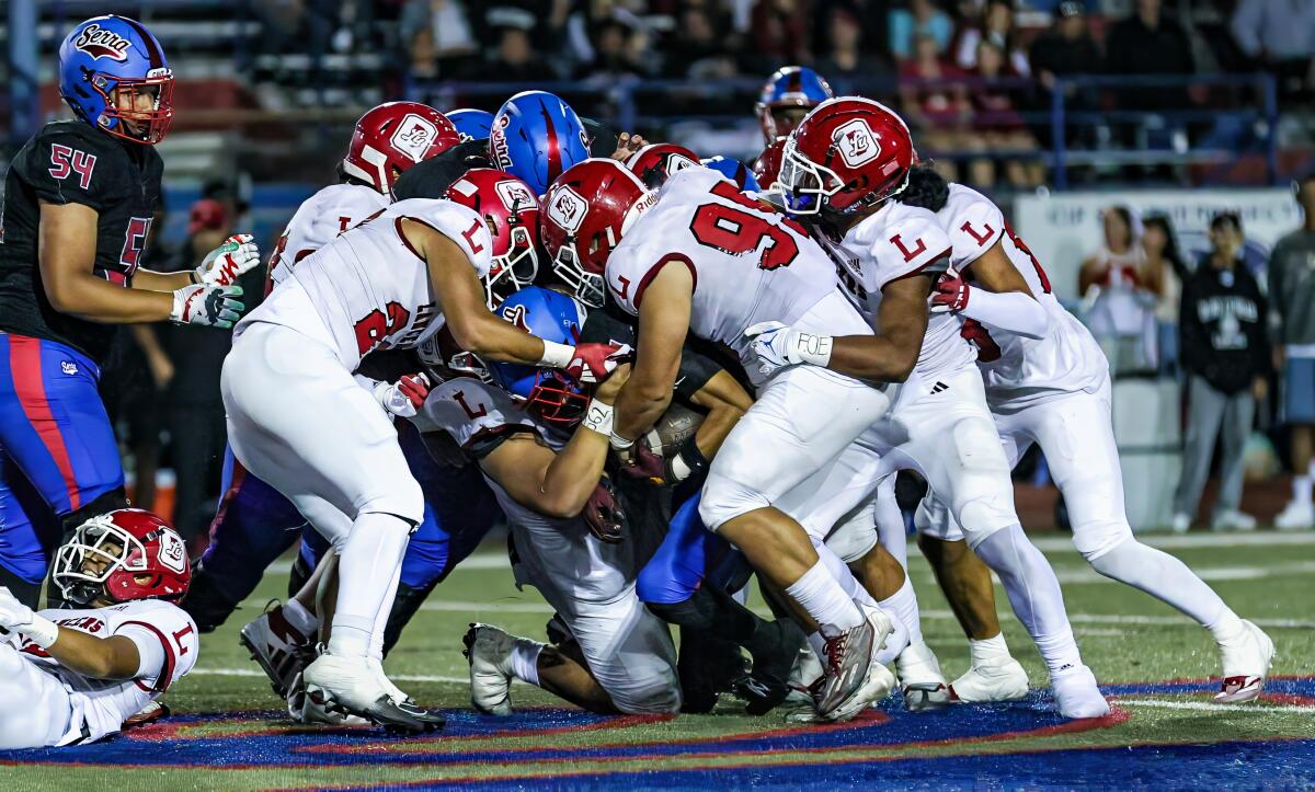 Orange Lutheran defense gets physical against Gardena Serra.