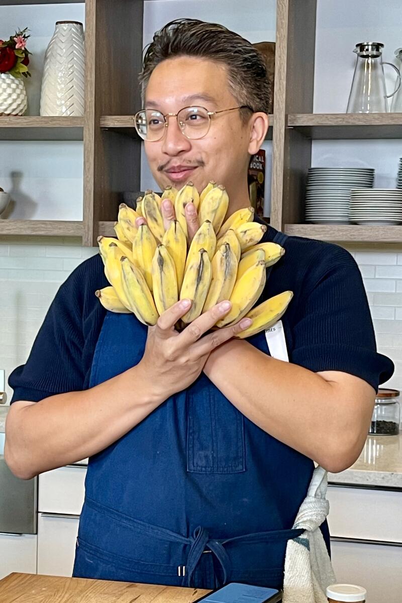 Anajak Thai chef Justin Pichetrungsi holding bananas in the L.A. Times test kitchen