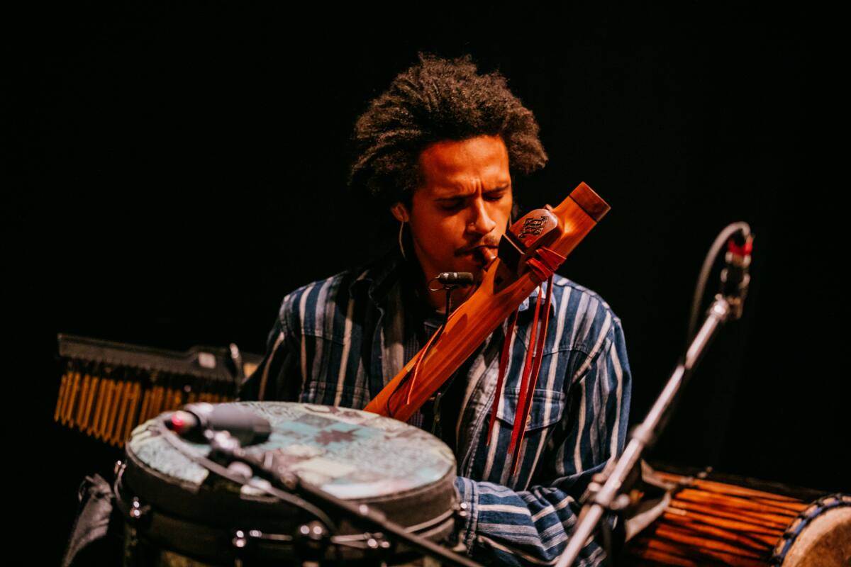 A man plays an instrument onstage