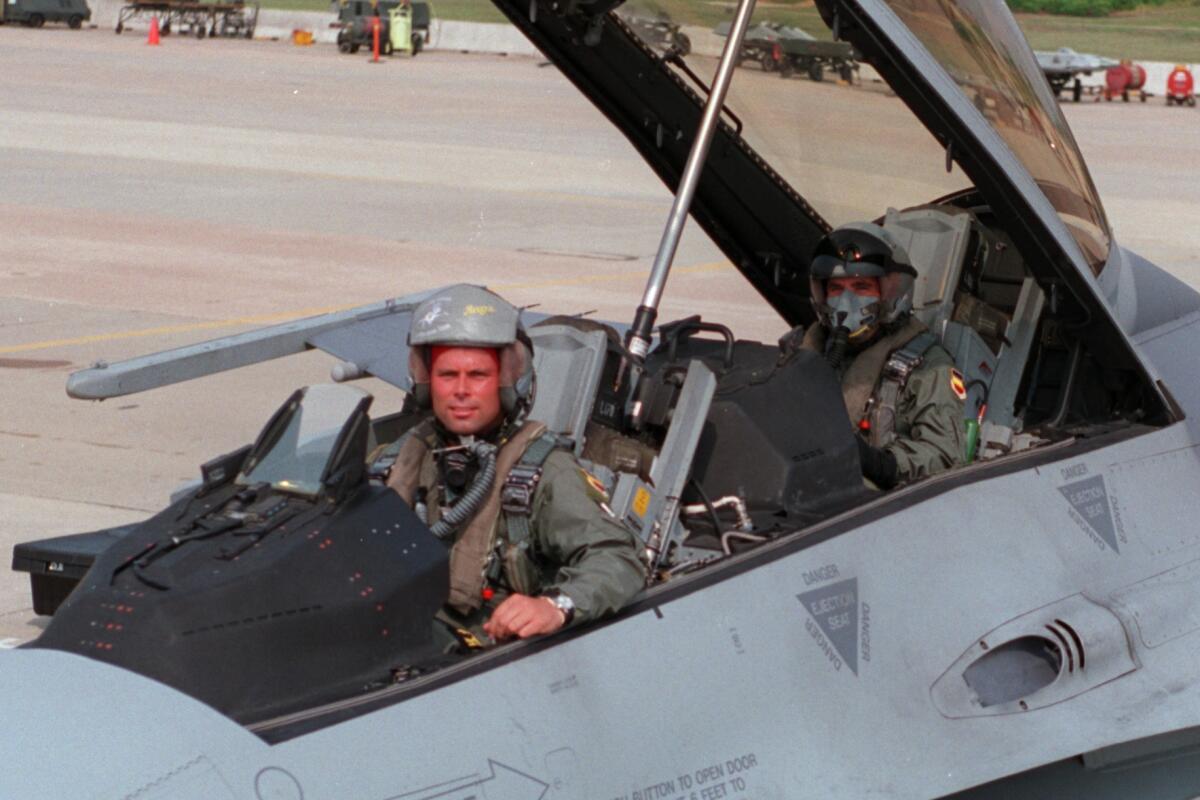 SF.F–16.1.0622.SN–– Sumter South CarolinaCaptain Randy Redell (front) and sportswriter Eric Sondheimer (rear) make final preparations in the cockpit before leaving on an 82 minute F–16 flight out of Shaw Air Force Base in Sumter, South CarolinaPhoto/Artby:Scott A Nichols/U.S. Air Force