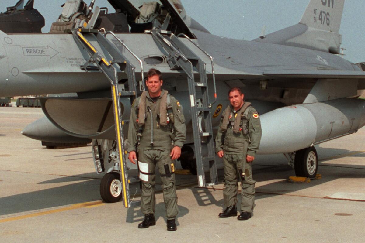 Former Crespi quarterback Randy Redell (left) and sportswriter Eric Sondheimer prepare for an F-16 flight.