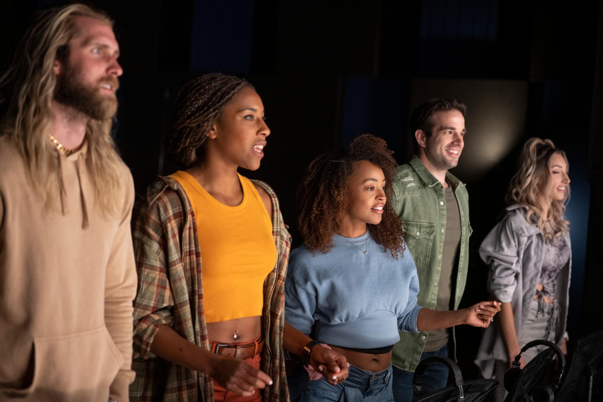 A group of people standing in the dark.