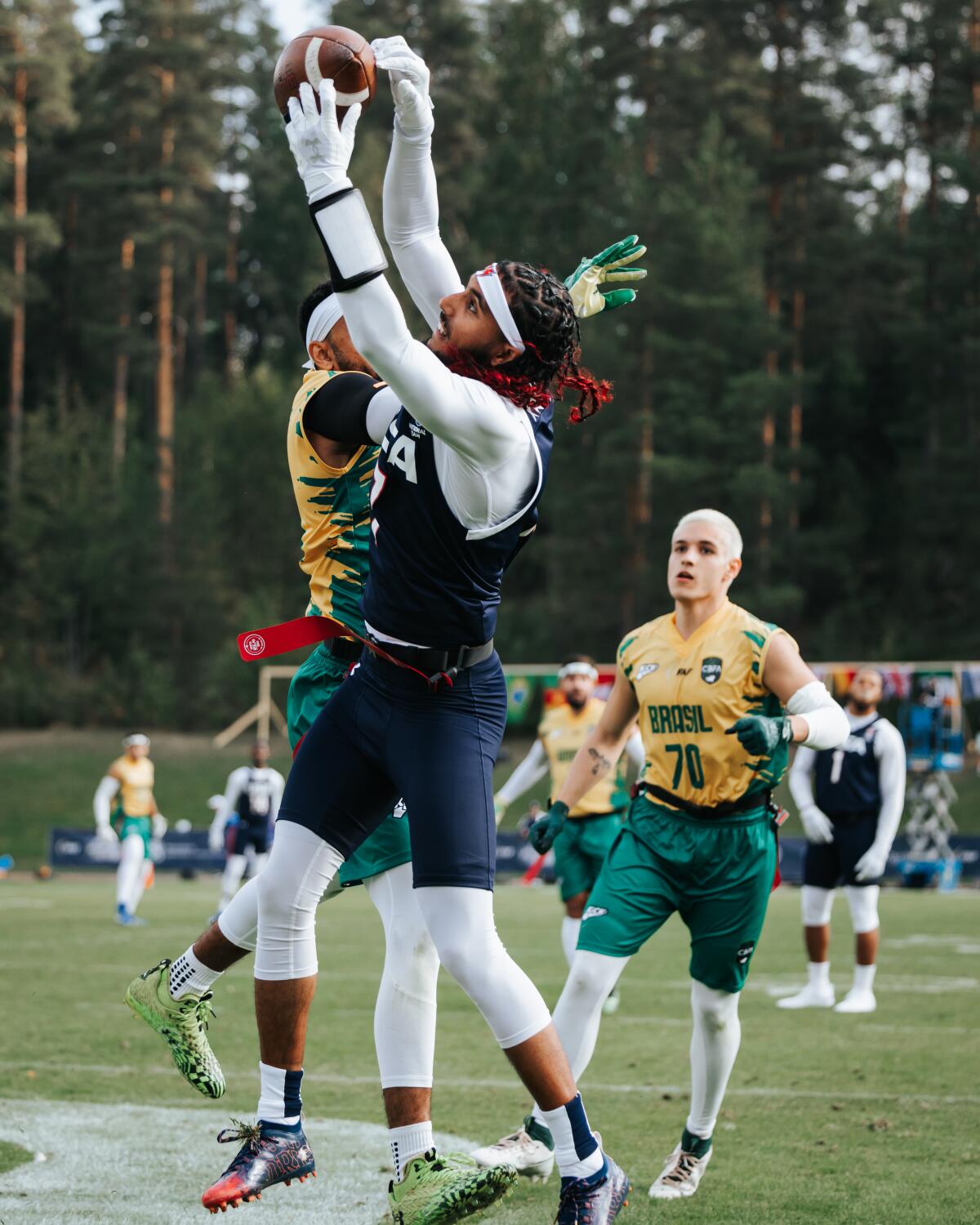 U.S. quarterback Darrell Doucette jumps in front of a defender to catch a touchdown pass.