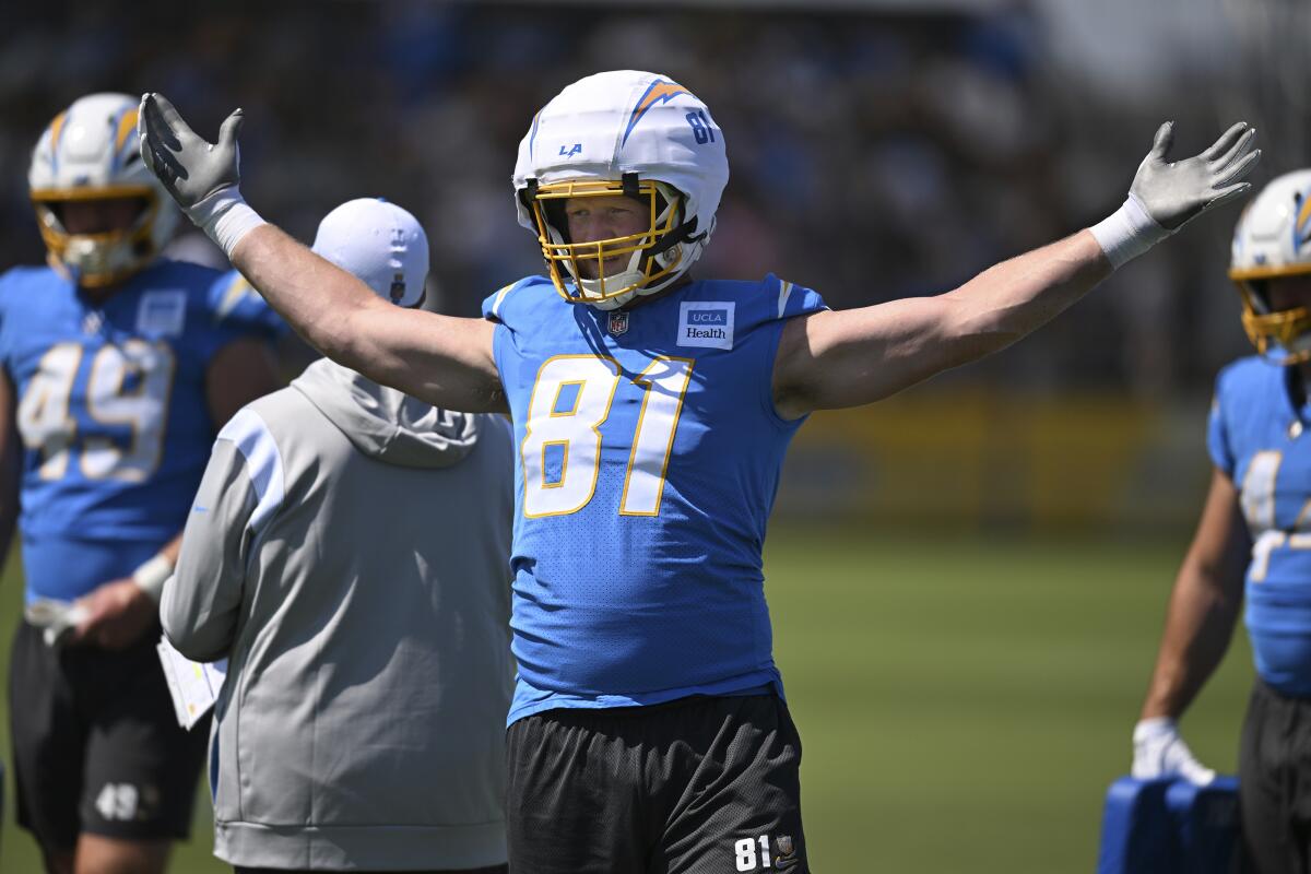 Chargers tight end Will Dissly extends his arms to both sides.