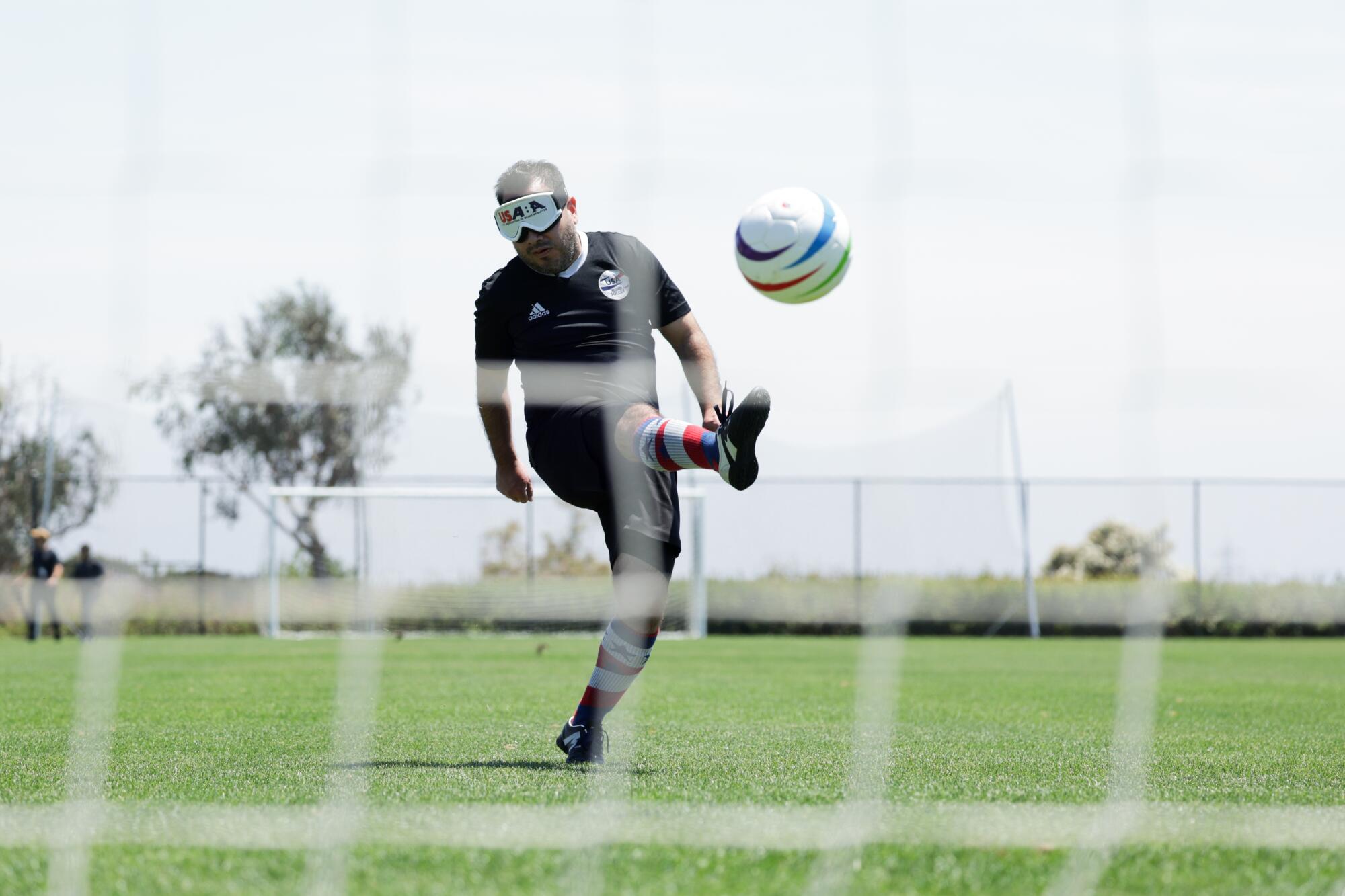 Parathlete soccer player Alvaro Mora Arellano kicking a ball