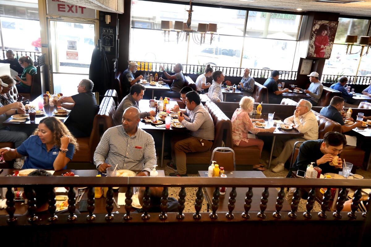 A restaurant filled with diners.