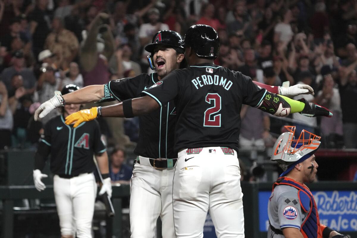 Diamondbacks outfielder Corbin Carroll celebrates with a teammate after hitting a grand slam against the Mets on Wednesday.