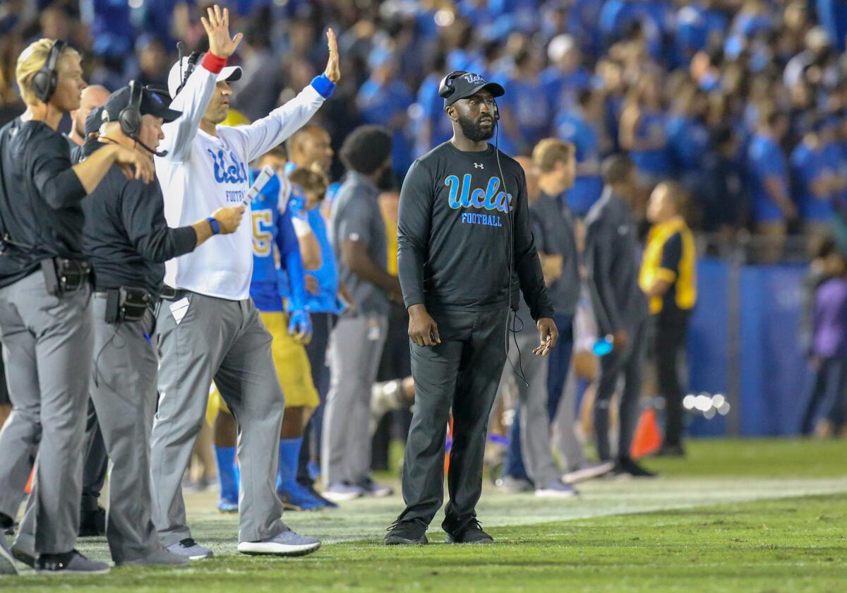 DeShaun Foster stands on the sideline during a game while working as the UCLA running backs coach