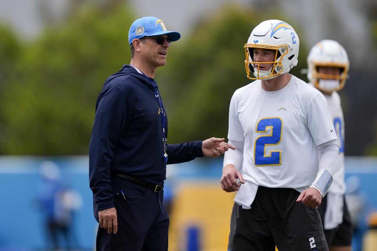 Chargers coach Jim Harbaugh talks to quarterback Easton Stick (2).