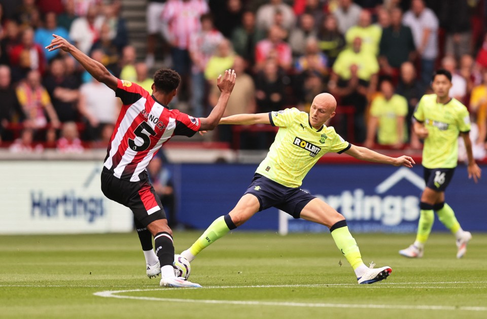 Saints' midfielder Will Smallbone tangles with Brentford’s Ethan Pinnock