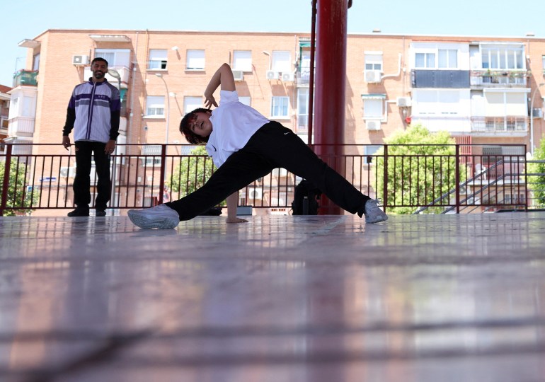 Afghan refugee and Breaking athlete Manizha Talash practices for the Paris 2024 Olympics where the sport will make its Olympic debut as coach David Vento looks on, in Madrid, Spain, June 11, 2024. REUTERS/Violeta Santos Moura