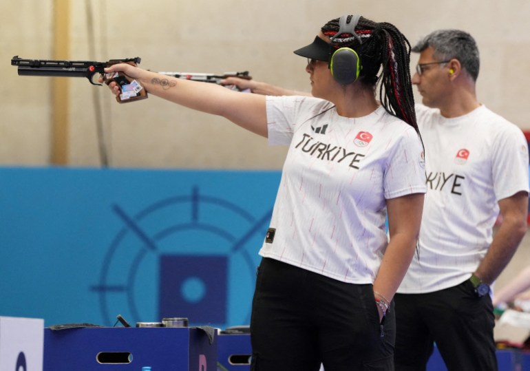 FILE PHOTO: Paris 2024 Olympics - Shooting - 10m Air Pistol Mixed Team Gold Medal - Chateauroux Shooting Centre, Deols, France - July 30, 2024. Sevval Ilayda Tarhan of Turkey (L) and Yusuf Dikec of Turkey in action. REUTERS/Amr Alfiky/File Photo