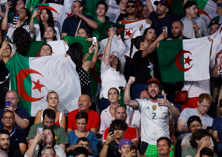 Paris 2024 Olympics - Boxing - Women's 66kg - Quarterfinal - North Paris Arena, Villepinte, France - August 03, 2024. Flags of Algeria are held up by spectators in the stands ahead of the fight between Imane Khelif of Algeria and Anna Luca Hamori of Hungary REUTERS/Peter Cziborra