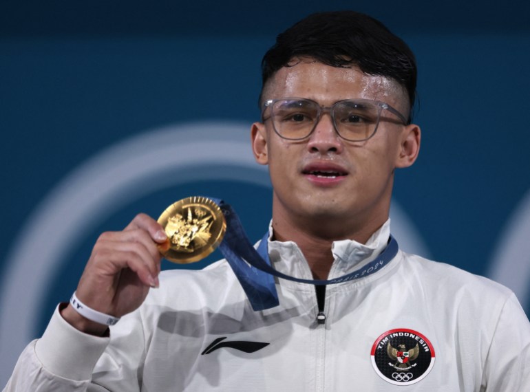 Rizki Juniansyah of Indonesia holds up his gold medal