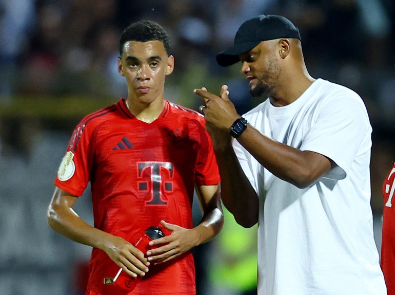 Coach and player at training field.