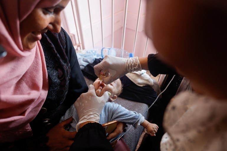 A Palestinian child is vaccinated against polio, amid the Israel-Hamas conflict, at Nasser hospital in Khan Younis in the southern Gaza Strip, August 31, 2024. REUTERS/Mohammed Salem