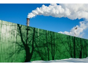 Chimneys emit vapor behind a perimeter fence with tree shadows at the Segezha Pulp and Paper Mill JSC, operated by Segezha Group, in Segezha, Russia, on Friday, March 19, 2021. Billionaire Vladimir Evtushenkov is considering an initial public offering of wood, paper and packaging producer Segezha Group after an ecommerce operator he holds a stake in notched the most successful Russian debut in nearly a decade last November. Photographer: Andrey Rudakov/Bloomberg