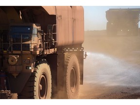 An autonomous water truck sprays water on an access road to minimise dust at the Rio Tinto's Gudai-Darri mine in the Pilbara Region of Western Australia, on Tuesday, 21 Jun. , 2022. Photographer: Carla Gottgens/Bloomberg