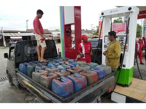 An attendant refuels jerry cans with diesel at a PT Pertamina gas station in Bone Regency, South Sulawesi, Indonesia, on Wednesday, Jan. 17, 2024. Indonesia's heads to the polls next month. The next leader will take over from Jokowi after nearly a decade in power. Photographer: Dimas Ardian/Bloomberg