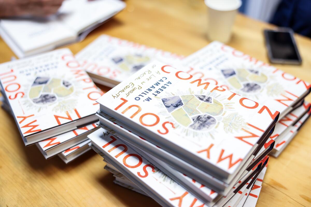 Books sitting on a wooden table.