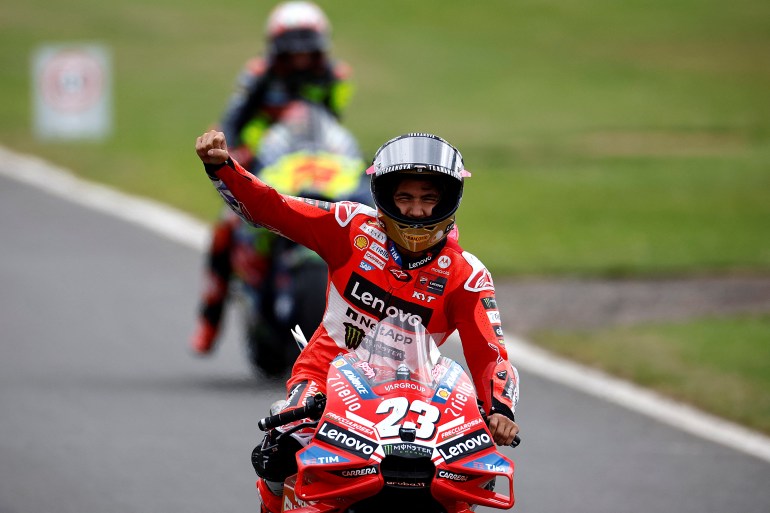 MotoGP rider waves to crowd.