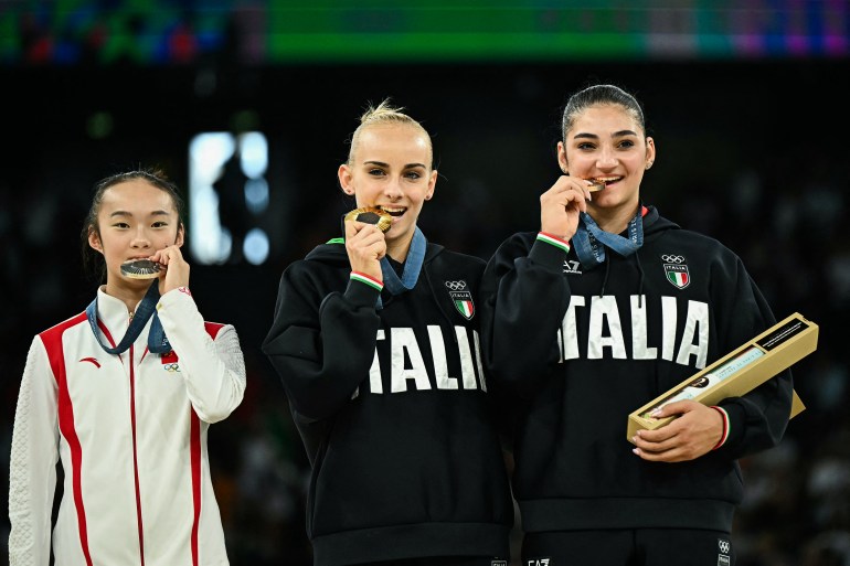 (LtoR) China's Zhou Yaqin (silver), Italy's Alice D'amato (gold) and Italy's Manila Esposito (bronze) pose during the podium ceremony for the artistic gymnastics women's balance beam event of the Paris 2024 Olympic Games at the Bercy Arena in Paris, on August 5, 2024. (Photo by Gabriel BOUYS / AFP)