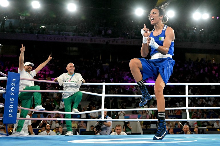 Algeria's Imane Khelif (Blue) reacts after beating Thailand's Janjaem Suwannapheng in the women's 66kg semi-final boxing match during the Paris 2024 Olympic Games at the Roland-Garros Stadium, in Paris on August 6, 2024. (Photo by MOHD RASFAN / AFP)