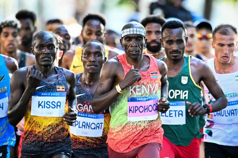 Kenya's Eliud Kipchoge and other athletes compete in the men's marathon of the athletics event at the Paris 2024 Olympic Games in Paris on August 10, 2024. (Photo by Kirill KUDRYAVTSEV / AFP)