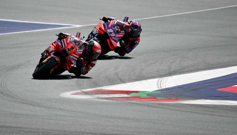 MotoGP riders on track.