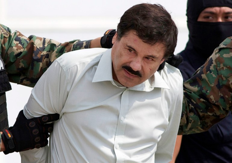 Joaquin "El Chapo" Guzman, the head of Mexico's Sinaloa Cartel, being escorted to a helicopter in Mexico City following his capture in the beach resort town of Mazatlan