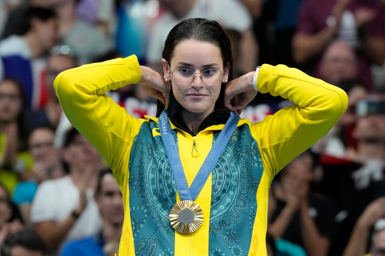 Kaylee McKeown of Australia, reacts after receiving her gold medal in the women's 200-meter backstroke final at the 2024 Summer Olympics, Friday, Aug. 2, 2024, in Nanterre, France. (AP Photo/Natacha Pisarenko)