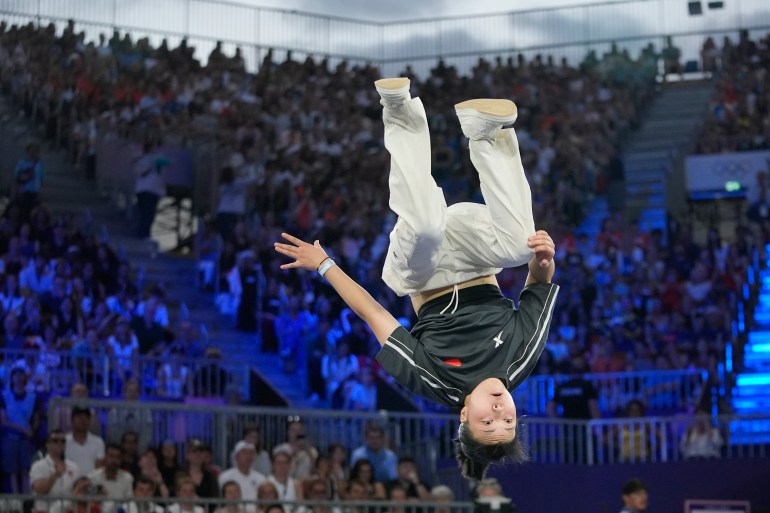 China's Qingyi Liu, known as B-Girl 671, competes during the B-Girls bronze medal battle at the breaking competition at La Concorde Urban Park at the 2024 Summer Olympics, Friday, Aug. 9, 2024, in Paris, France. (AP Photo/Frank Franklin)