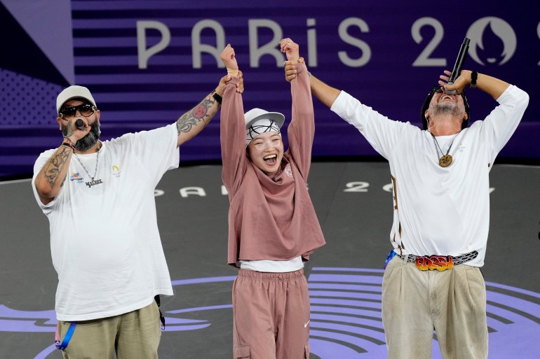 Japan's Ami Yuasa, known as B-Girl Ami, celebrates after winning the gold medal during the B-Girls gold medal battle at the breaking competition at La Concorde Urban Park at the 2024 Summer Olympics, Friday, Aug. 9, 2024, in Paris, France. (AP Photo/Abbie Parr)