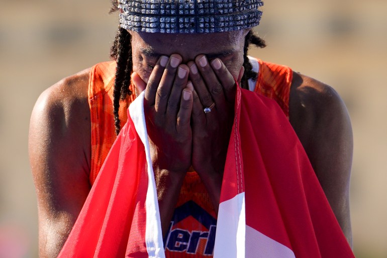 Sifan Hassan, of the Netherlands, reacts after crossing the finish line to win the gold medal at the end of the women's marathon competition at the 2024 Summer Olympics, Sunday, Aug. 11, 2024, in Paris, France. (AP Photo/Vadim Ghirda)