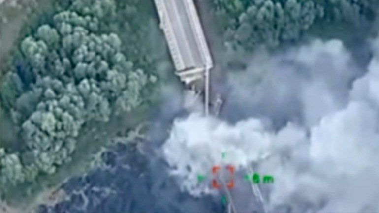 Aerial photo shows plume of smoke over a bridge