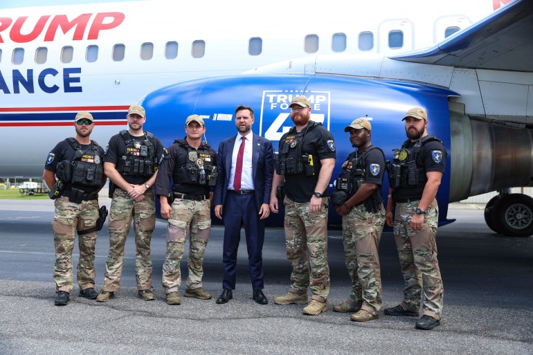 JD Vance poses in front of a Trump campaign plane with members of Lowndes County sheriff's office. 