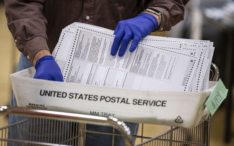 Canvassers process mail-in election ballots at a sorting facility in Gaithersburg, Maryland on Thursday, October 29, 2020. The workers check for authenticity and errors before tabulating the vote. Voting by mail has soared in the run up to the November 3rd 2020 presidential election due to the COVID-19 pandemic. Photo by Kevin Dietsch/UPI