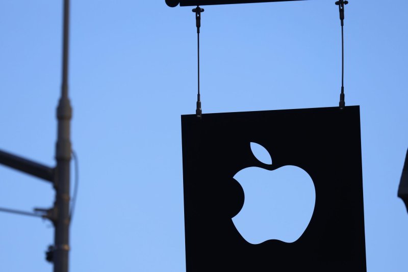 The Apple logo hangs outside of an Apple retail store in the SoHo Section of Manhattan in New York City on March 21. Apple announced that it will change chief financial officers on January 1. File Photo by John Angelillo/UPI