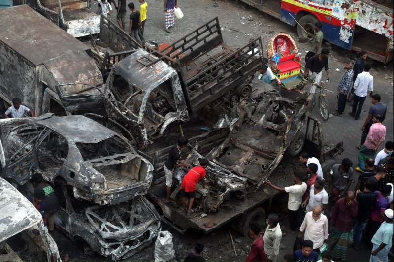 Bystanders at Dhaka's Japrabari police station on Tuesday inspect the aftermath of mass protests in the capital and across Bangladesh that ended 15 years of rule by the country's unpopular leader, Prime Minister Sheikh Hasina. Photo by Monirul Alam/EPA-EFE