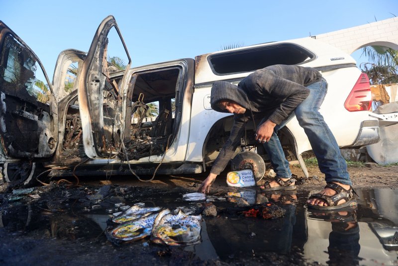 A Palestinian man inspects the carcass of a car used by U.S.-based aid group World Central Kitchen that was hit by an Israeli strike in Deir al-Balah in the central Gaza Strip on April 1. On Friday, Australia said serious failures committed by Israeli resulted in the strike that killed seven WCK workers. File Photo by Ismael Mohamad/UPI