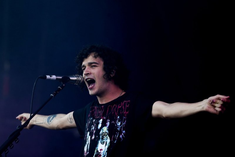 British rock band 1975 lead singer Matt Healy (seen in Portugal in July 2016) has been sued in a British court by event organizers in Malaysia stemming from last year's same-sex kiss onstage with fellow band member Ross MacDonald. File Photo by Jose Sena Goulao/EPA-EFE