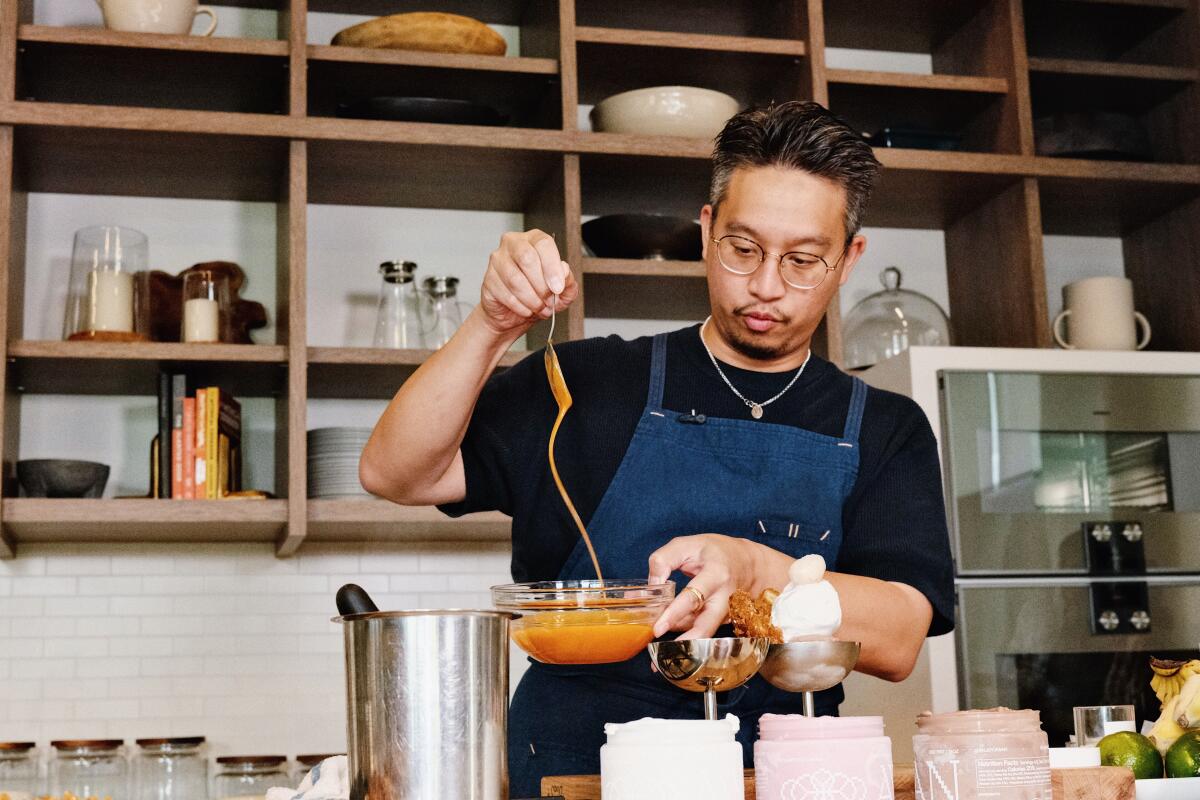 Chef Justin Pichetrungsi prepares an ice cream sundae with Thai tea caramel at the Los Angeles Times test kitchen